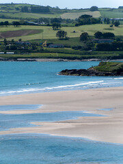 Inchydoney beach at low tide on a sunny spring day. The famous Irish beach on the south coast of the country. Seaside landscape.