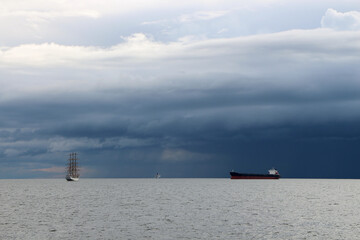 A tanker and a three-masted sailing frigate are moving towards each other