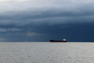 Tanker on the high seas against the backdrop of storm clouds