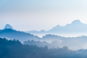 Mountains and forest in fog, mountain range with morning sky landscape.