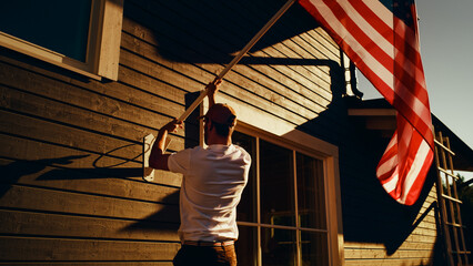 Patriotic Homeowner Raising the United States of America National Flag on His Neighborhood Home....