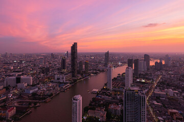 Fototapeta na wymiar Aerial view of Bangkok Downtown Skyline, Thailand. Financial district and business centers in smart urban city in Asia. Skyscraper and high-rise buildings with Chao Phraya River.