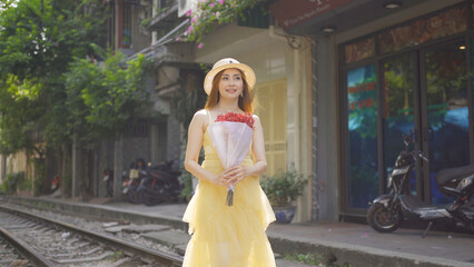 Naklejka premium Portrait of Asian Vietnamese woman girl with train railway traveling in Hanoi urban city town, Vietnam. People lifestyle.