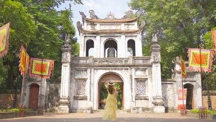 Obraz premium Portrait of Asian Vietnamese woman girl in local temple traveling in Hanoi urban city town, Vietnam. People lifestyle.