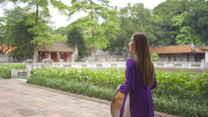 Portrait of Asian Vietnamese woman girl in local temple traveling in Hanoi urban city town, Vietnam. People lifestyle.