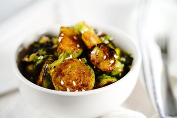 Roasted Teriyaki Brussels sprouts served in a bowl, selective focus
