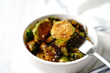 Roasted Teriyaki Brussels sprouts served in a bowl, selective focus