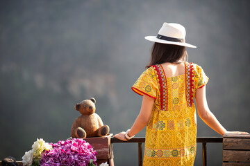 a woman standing watching the beauty of the mountain scenery