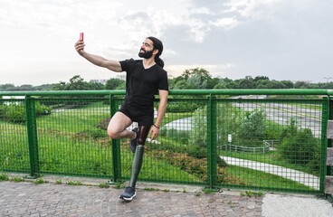 Hispanic man with prosthetic leg taking selfie after workout routine