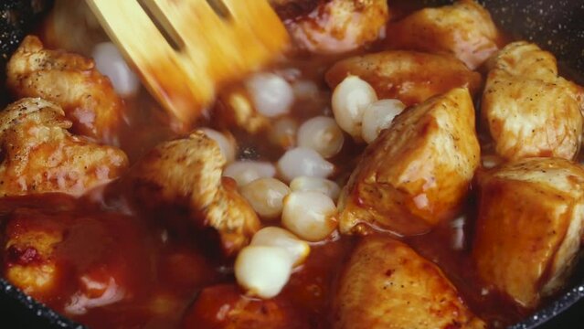 cooking meat burgundy in red tomato sauce