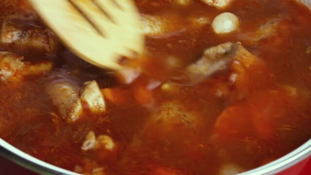 cooking red sauce with tomatoes, carrots and onions