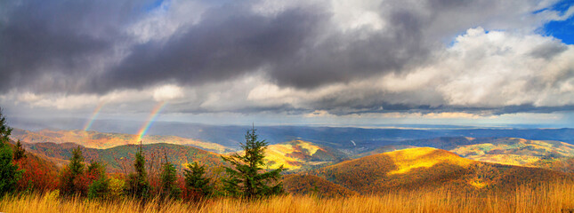 Autumn landscape, panorama, banner - view of mountains covered with mountain forests and meadows under autumn sky after rain, Carpathians, Ukraine