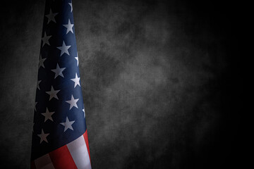 USA flag on a dark background. American flag on the background of a dark canvas for a patriotic...