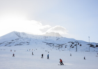 Erciyes, Kayseri, Turkey - 02.23.2022: Skiers go downhill skiing on snow-covered mountain ski slope...