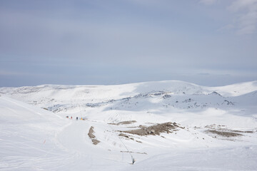 Snow-covered mountains in a European ski resort against a blue cloudy sky. Nature, beautiful views.  Vacation. Travel content