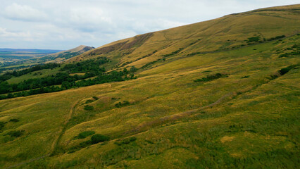 Fototapeta premium The green hills of Peak District National Park - drone photography