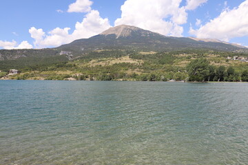 Alpine landscape in the Hautes-Alpes with on the mountains, lake and sky.