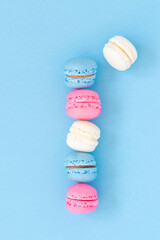 Colorful macaron  food art, empty space on blue background