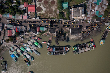 Aerial view of boats along the riverbank unloading coal, Bhairab Upazila, Kishoreganj, Bangladesh.