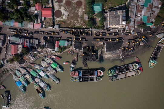 Aerial view of boats along the riverbank unloading coal, Bhairab Upazila, Kishoreganj, Bangladesh.