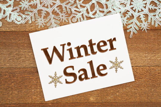 Winter Sale message on a greeting card with white snowflakes