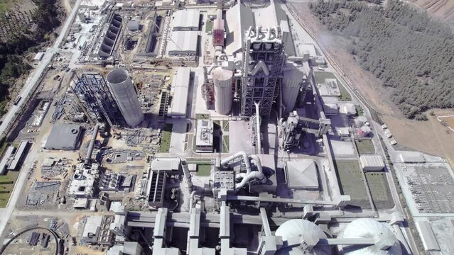 Structures of cement producing plant. Aerial view of huge industrial factory. 