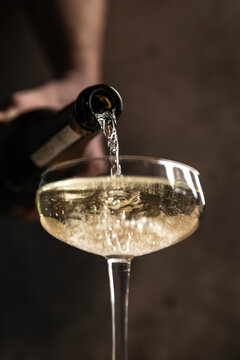 Prosecco pour into coupe glass