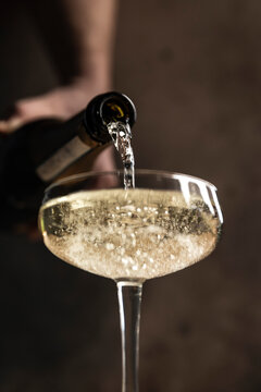 Prosecco pour into coupe glass