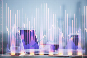 Stock market graph on background with desk and personal computer. Double exposure. Concept of financial analysis.