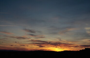 cloudy sky and various colorful ligts during sunset at evening