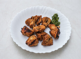 Chicken tikka boti kebab served in plate isolated on table top view of indian and pakistani spicy food