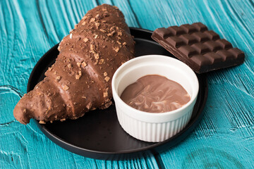 Freshly chocolate croissant on plate