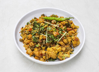 mix vegetable with gobhi, bhindi, matar served in plate isolated on table top view of indian and pakistani spicy food
