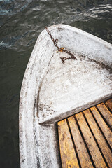 The bow of a rowboat with wooden planks from above