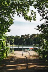 Deck chairs in summer on a jetty at a forest lake