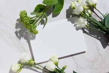empty blank card, flowers white background. Elegant modern mockup flat lay. Copy space.
