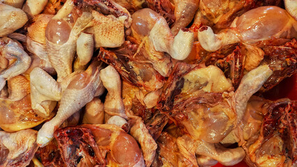 Chicken leg meat at the butcher shop display in traditional market. Raw meat.