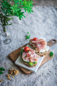 Avocado and ham on toast with tomato