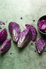 Purple cabbage slices on green background