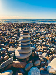 Obraz premium Ocean water splash on rock beach with beautiful sunset sky and clouds. Sea wave splashing on stone at sea shore