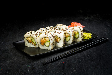 sushi on a black plate