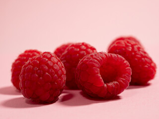 Raspberries on a pink background. Fresh raspberries.