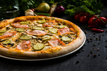 Pizza with ham, pickles and mushrooms