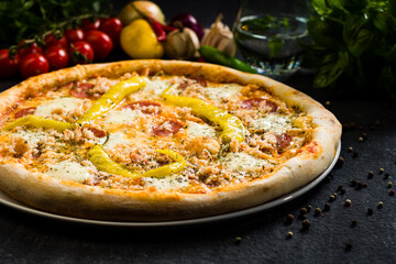 Pizza with salami, mozzarella and green peppers