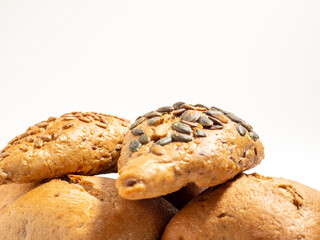 Dark buns on a white background. Bakery products with grains.