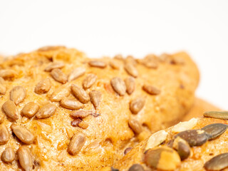 Dark buns on a white background. Bakery products with grains.