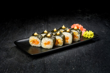 sushi on a black plate
