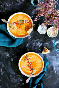 Red Lentil Piquillo Pepper Bisque in white bowls with blue napkins