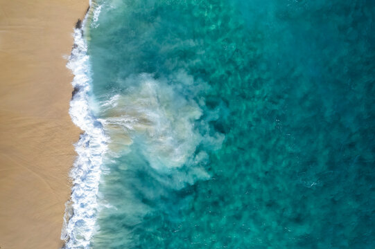 Aerial view of crispy waves along the shoreline at Playa de los Amantes, Cabo San Lucas, Baja California, Mexico.