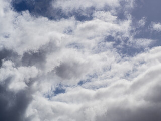 Rainy clouds formation under a blue sky.